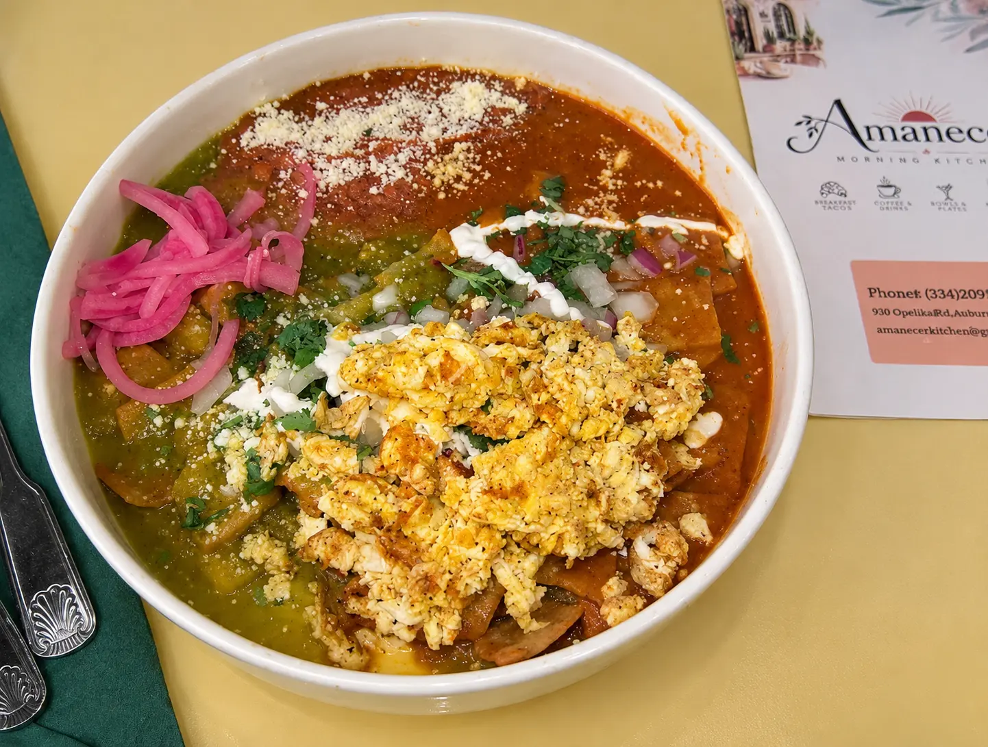 Chilaquiles with red and green salsa, scrambled eggs, crema and queso fresco